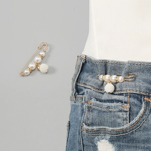 Pearl safety pin brooch for waist tightening dress decor, elegant crystal design detail display.