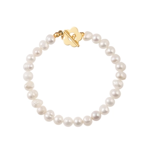 Detail of freshwater pearl bracelet featuring a unique gold flower-shaped toggle clasp