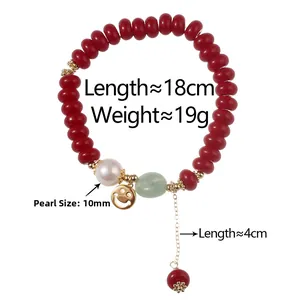 Close-up of red beaded bracelet with white pearl, green stone, and golden smiley charm
