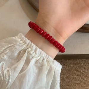 Minimalist red beaded bracelet with polished round beads for a retro Chinese aesthetic