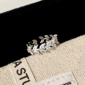 Macro shot of silver-tone leaf open ring with marquise cubic zirconia on black velvet