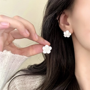 Elegant white floral stud earrings with cubic zirconia inlay and pearlescent finish