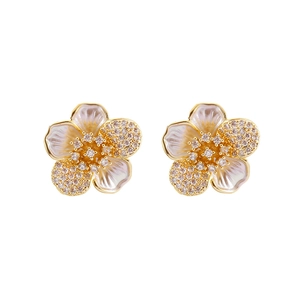 Elegant gold five-petal flower stud earrings with white inlay and pavé crystals