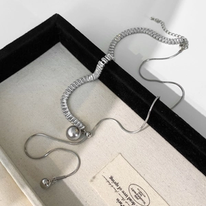 Elegant silver-tone necklace featuring rectangular crystals and a large grey pearl pendant