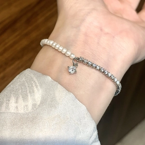 Elegant pearl and zircon splice bracelet with sparkling crystals on a female wrist