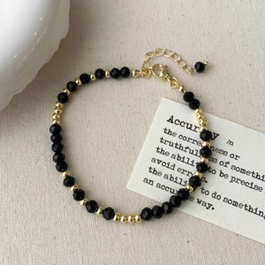Detail of vintage black crystal beaded necklace with gold spacers and adjustable clasp