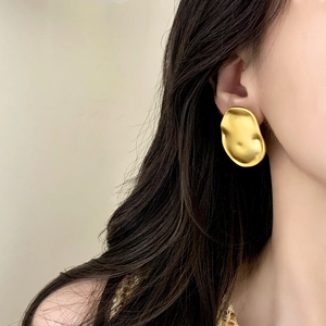 Elegant gold brushed irregular statement stud earrings with a luxury organic molten design