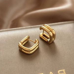 Elegant gold double-layered C-shaped earrings with a polished metallic finish