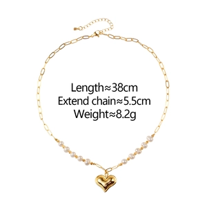 Gold-plated chain necklace with small pearls and a 3D heart pendant on white background