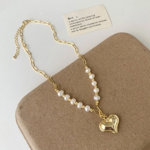 Detail of freshwater pearl heart necklace with gold paperclip chain and lobster clasp