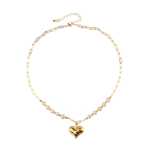 Chic heart pendant necklace featuring gold paperclip chain and freshwater pearls