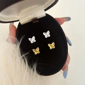 Elegant gold and silver butterfly stud earrings set in a premium jewelry box