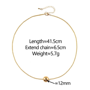 Minimalist gold snake chain necklace with a polished bead pendant on white background