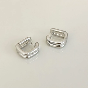 Detailed view of minimalist double-layered square hoop earrings with polished silver finish