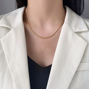 Minimalist gold spiral chain necklace for women styled on a professional model