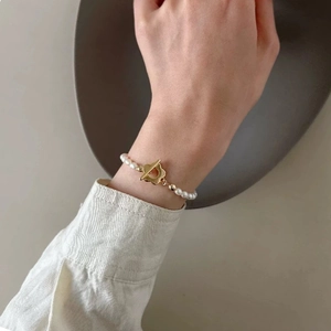 Elegant freshwater pearl necklace with gold flower OT buckle shown on a model