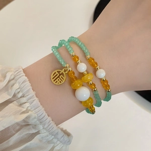 Three-layer green crystal bead bracelet for women featuring a gold Fu character charm