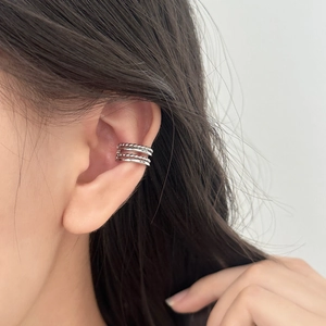 Minimalist multi-layer silver ear cuff featuring smooth and beaded metallic textures