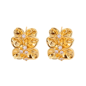 Exquisite gold floral stud earrings with cubic zirconia petals on a clean white background