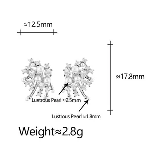 Irregular snowflake pearl stud earrings with sparkling cubic zirconia on a white background
