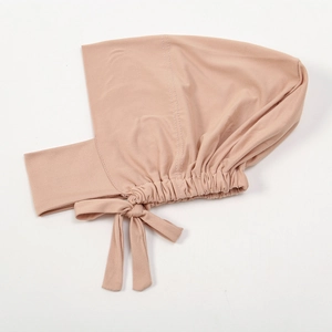 Detail of beige milk silk hijab inner cap with side bow tie and elastic pleated edge