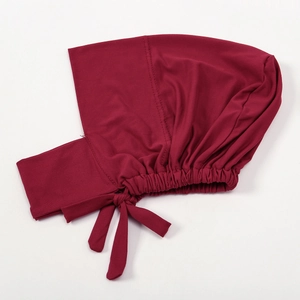 Detail of dark red elastic hijab inner cap showing soft milk silk fabric and fine stitching