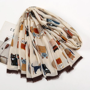 Close-up of soft beige polyester scarf featuring cute colorful cartoon cat print details