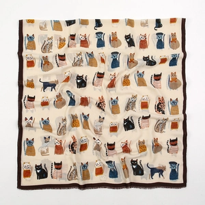 Detail of soft polyester scarf featuring colorful cartoon cat illustrations and brown hem
