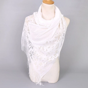 Close-up of white floral lace scarf featuring intricate crochet and elegant long tassels