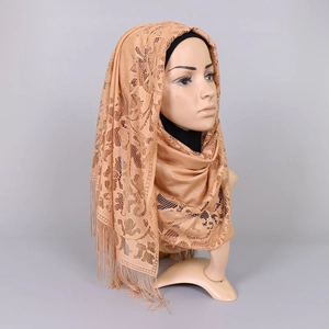 Detailed close-up of hollow floral lace hijab with elegant champagne gold tassels