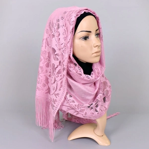 Detail of light pink lace long scarf featuring hollow floral patterns and fringe edges