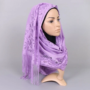 Close-up of purple lace hijab with hollow floral patterns and fringe details