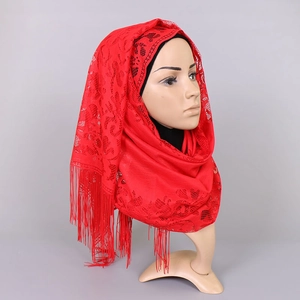 Detail of red floral lace hijab with intricate hollow-out patterns and long fringe trim