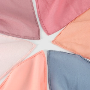 Detail view of pearl chiffon shawl texture showing breathable fabric and stitching quality