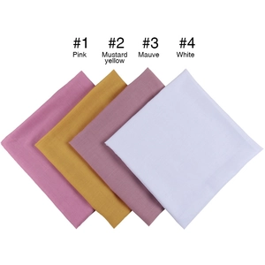 Folded square cotton linen scarves in pink, mustard yellow, mauve, and white color options