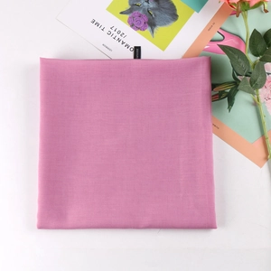 Detail of a mauve square viscose headscarf showing neat edges and smooth fabric texture