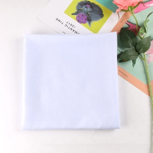 Detail of pure white solid square headscarf showing fine plain weave fiber texture