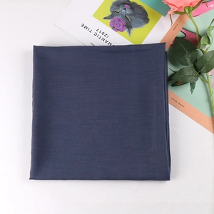 Detailed view of navy blue solid color square scarf with fine plain weave texture
