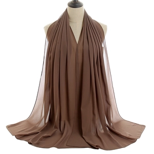 Detail of dark brown breathable chiffon scarf with premium hemmed edges and drape