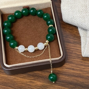 Close-up of green agate beaded bracelet with gold accents in a premium jewelry gift box