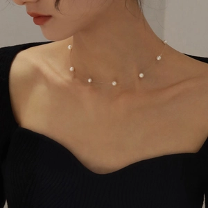 Elegant invisible floating pearl choker with seven round pearls on a clear thin wire