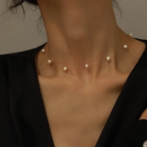 Elegant floating pearl necklace on invisible fishing line worn on female neck