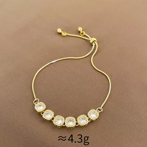 Detail view of gold zircon bracelet with adjustable slider clasp and snake chain link