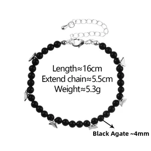 Detailed view of black agate beaded bracelet with silver butterfly charms and extension chain
