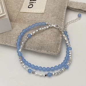 Elegant double-layered bracelet with light blue beads and faceted silver metallic beads