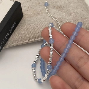 Minimalist double layer bracelet featuring light blue natural stones and silver beads
