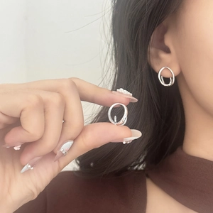 Silver geometric abstract line earrings with polished finish shown on model
