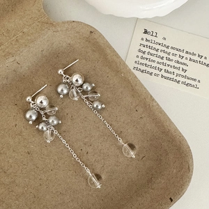 Detailed macro view of French vintage tassel earrings with pearls on craft paper