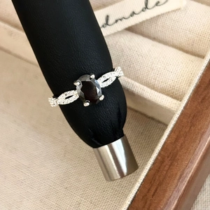 European vintage silver ring with oval black gemstone and pavé diamond twisted band