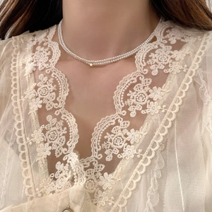 Elegant multi-layered pearl necklace with a gold bead accent for a sophisticated look
